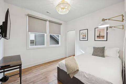 a bedroom with a bed and a window