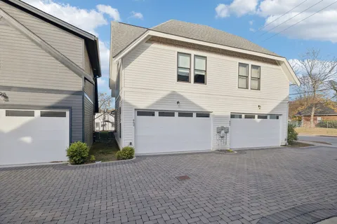 a view of a house with a yard and garage