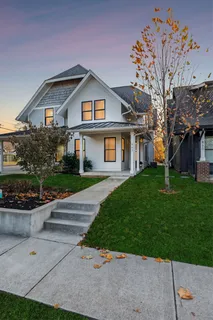 a front view of house with yard and green space