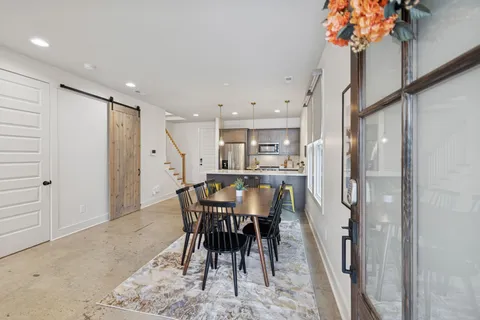 a view of a dining room with furniture and a potted plant