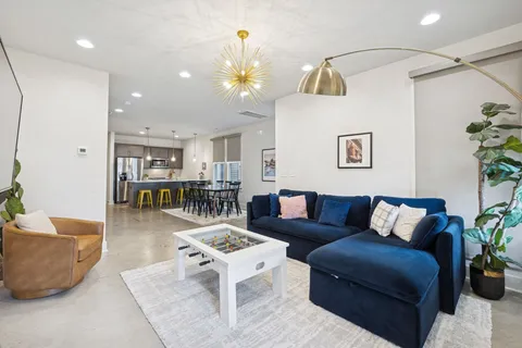 a living room with furniture and wooden floor