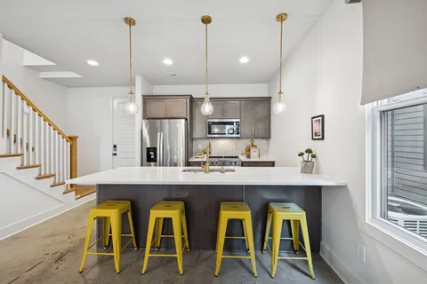 a open kitchen with furniture and a chandelier