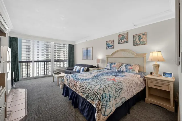 a bedroom with a bed couch and a window