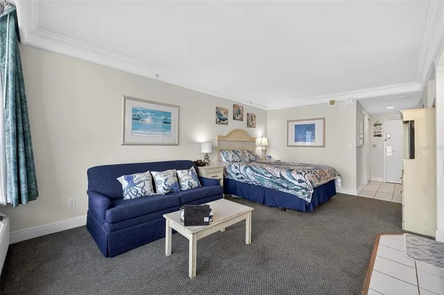 a bedroom with a bed and a couch