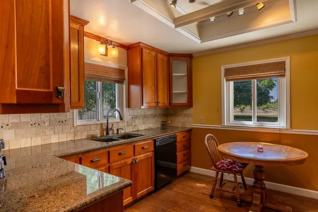 a kitchen with a sink a table and chairs