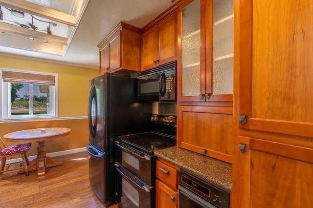 a kitchen with stainless steel appliances a refrigerator and a stove