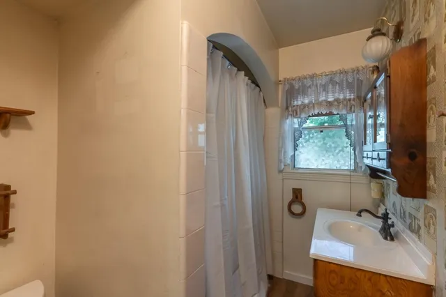 a bathroom with a sink vanity and a mirror