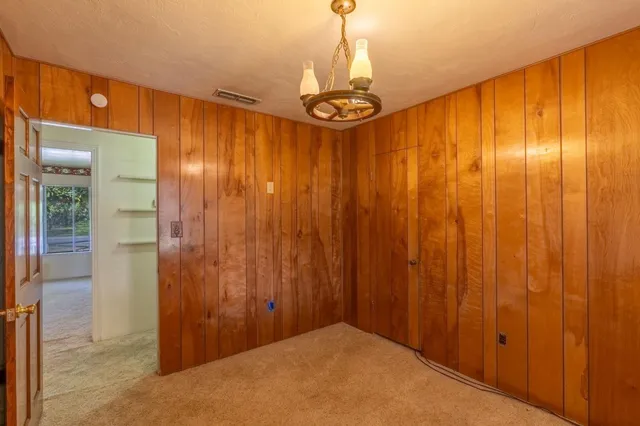 a view of a hallway with a chandelier