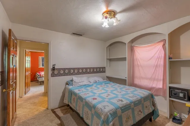 a bedroom with a bed and a chandelier