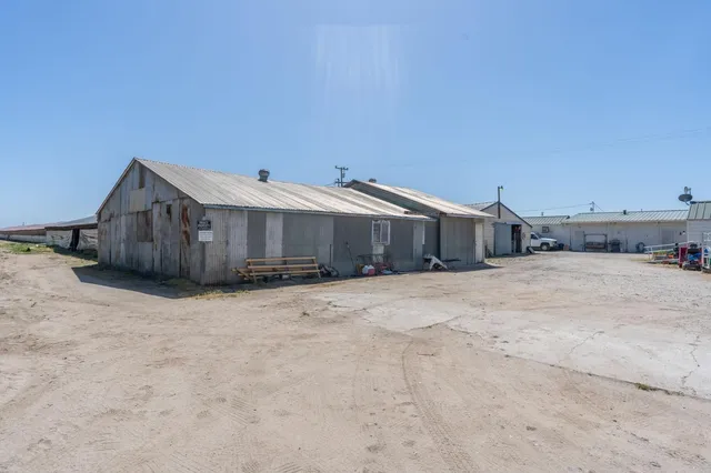 a view of a house with wooden fence