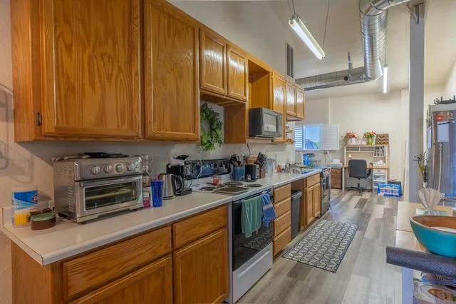 a kitchen with lots of counter top space and wooden floor