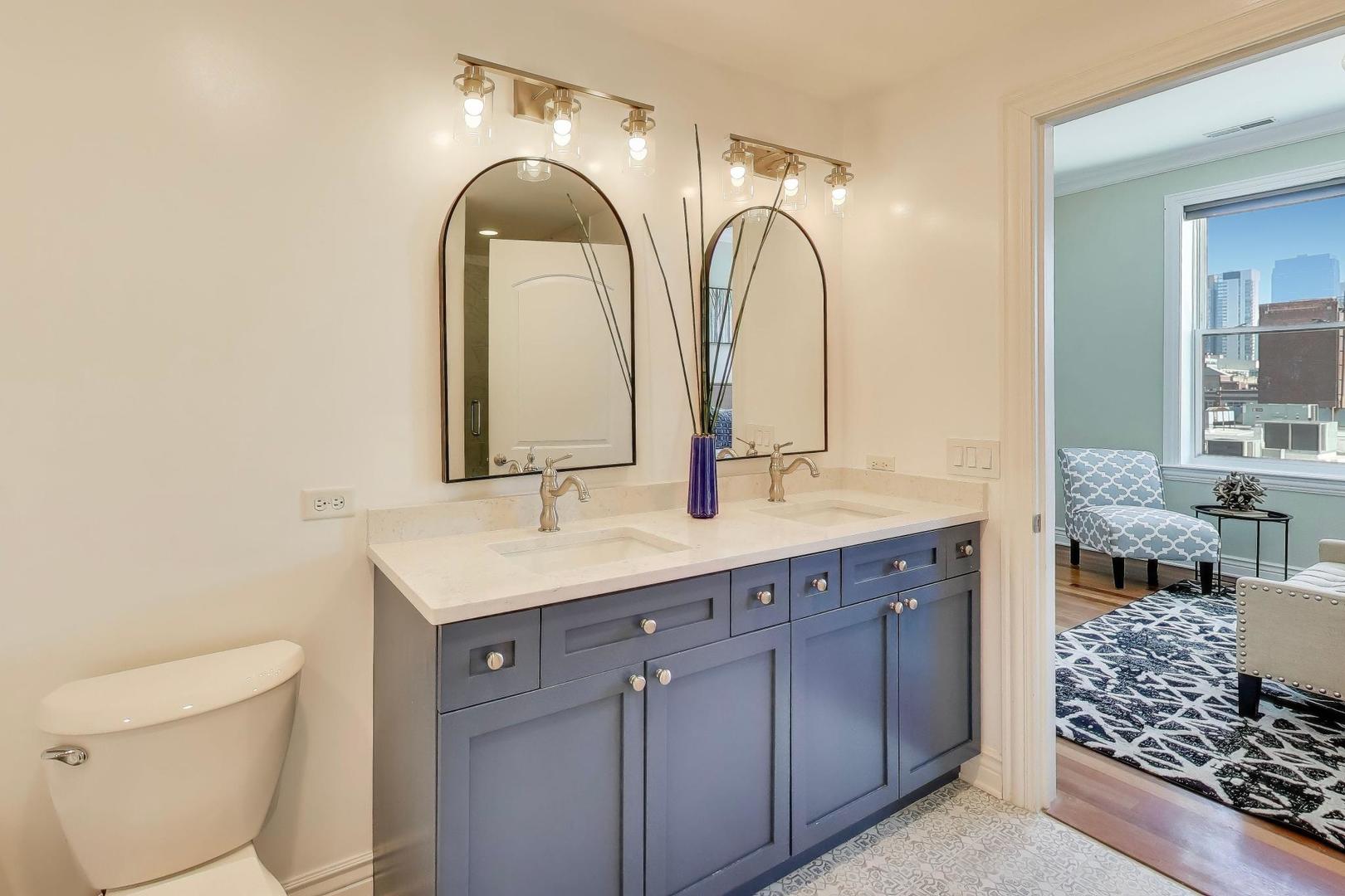 1148 West Monroe Street, Unit 5NE Chicago, IL 60607 - Photo 12 of 21 a bathroom with a double vanity sink and a mirror