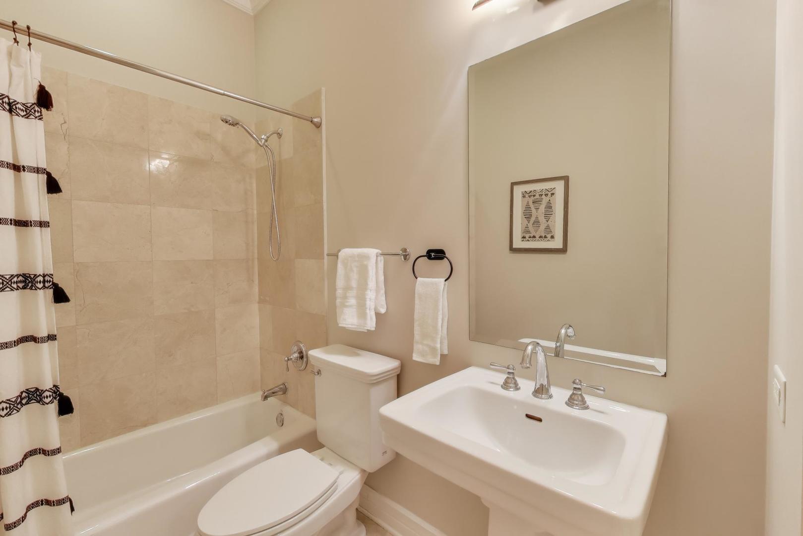 1148 West Monroe Street, Unit 5NE Chicago, IL 60607 - Photo 17 of 21 a bathroom with a sink toilet and shower