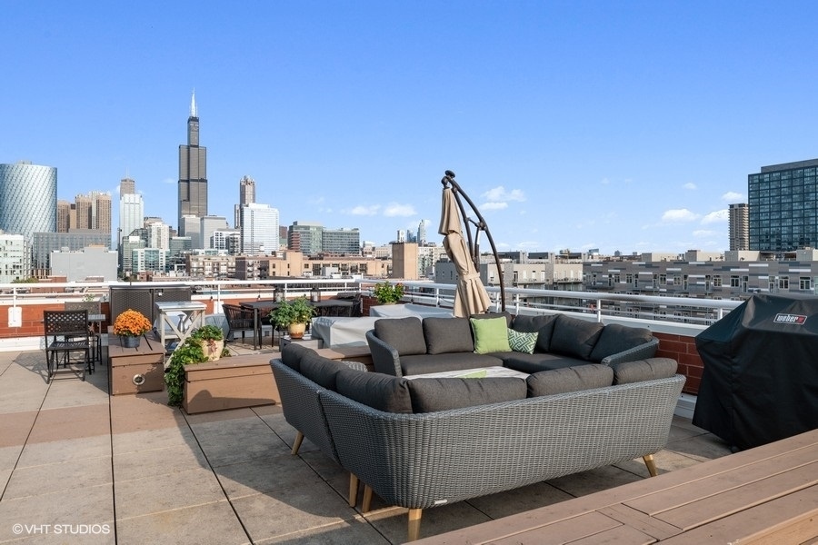 1148 West Monroe Street, Unit 5NE Chicago, IL 60607 - Photo 20 of 21 a view of a roof deck with couches and potted plants