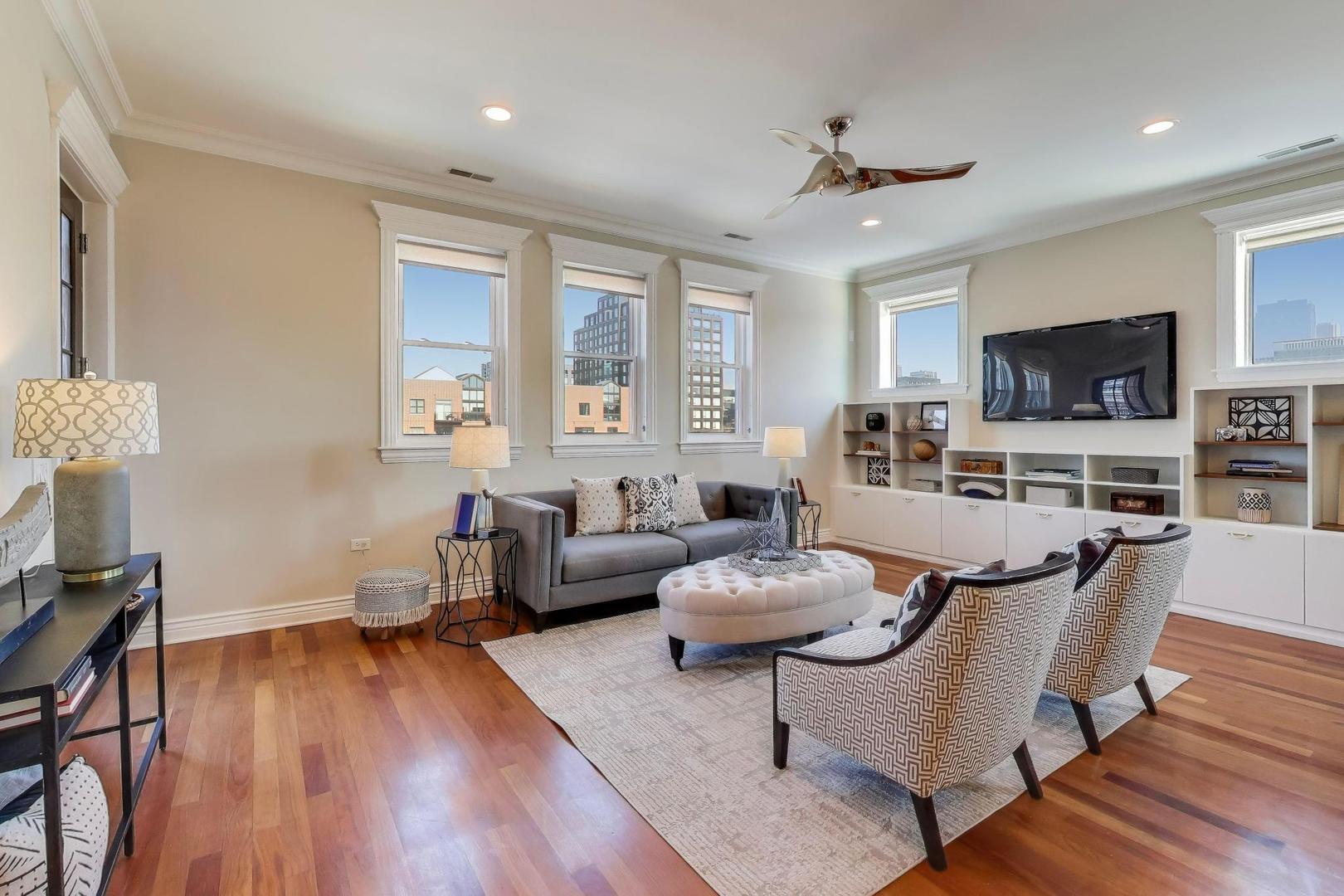 1148 West Monroe Street, Unit 5NE Chicago, IL 60607 - Photo 3 of 21 a living room with fireplace furniture and a flat screen tv