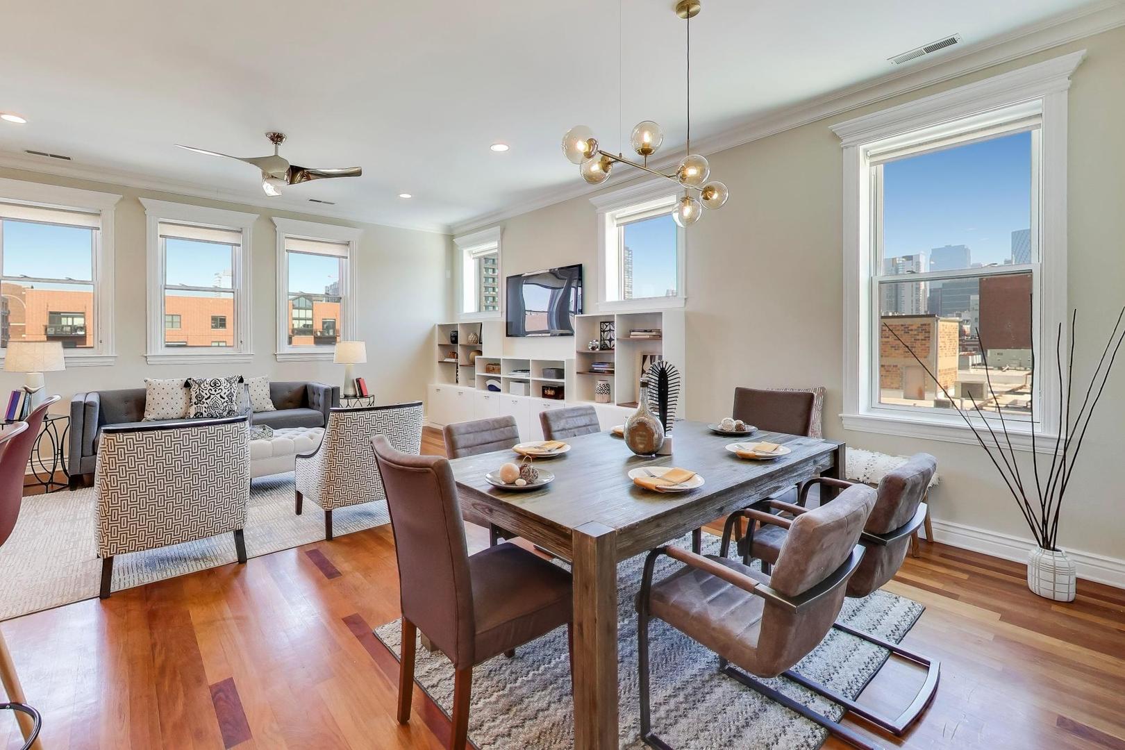 1148 West Monroe Street, Unit 5NE Chicago, IL 60607 - Photo 6 of 21 a view of a dining room with furniture window and wooden floor