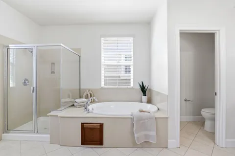 a bathroom with a granite countertop sink a toilet and shower