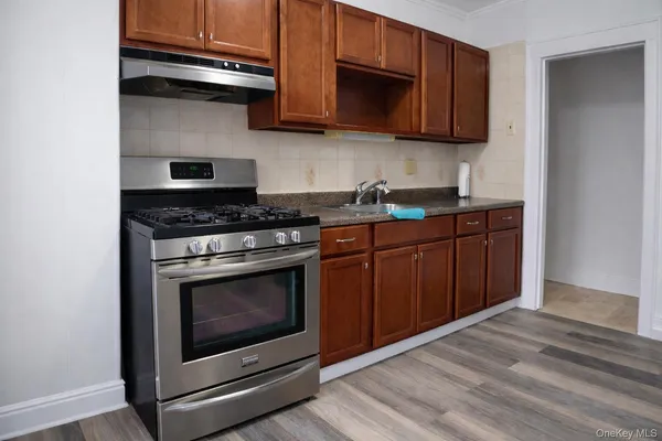 a kitchen with stainless steel appliances granite countertop a stove and a microwave