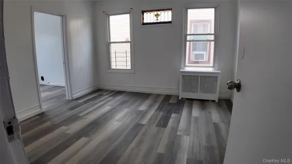 a view of a room with wooden floor and windows