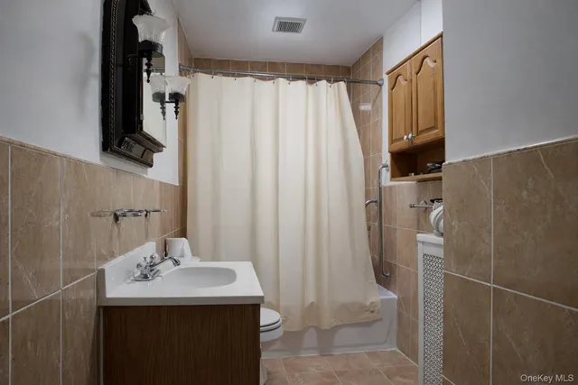a bathroom with a sink a mirror and shower curtain
