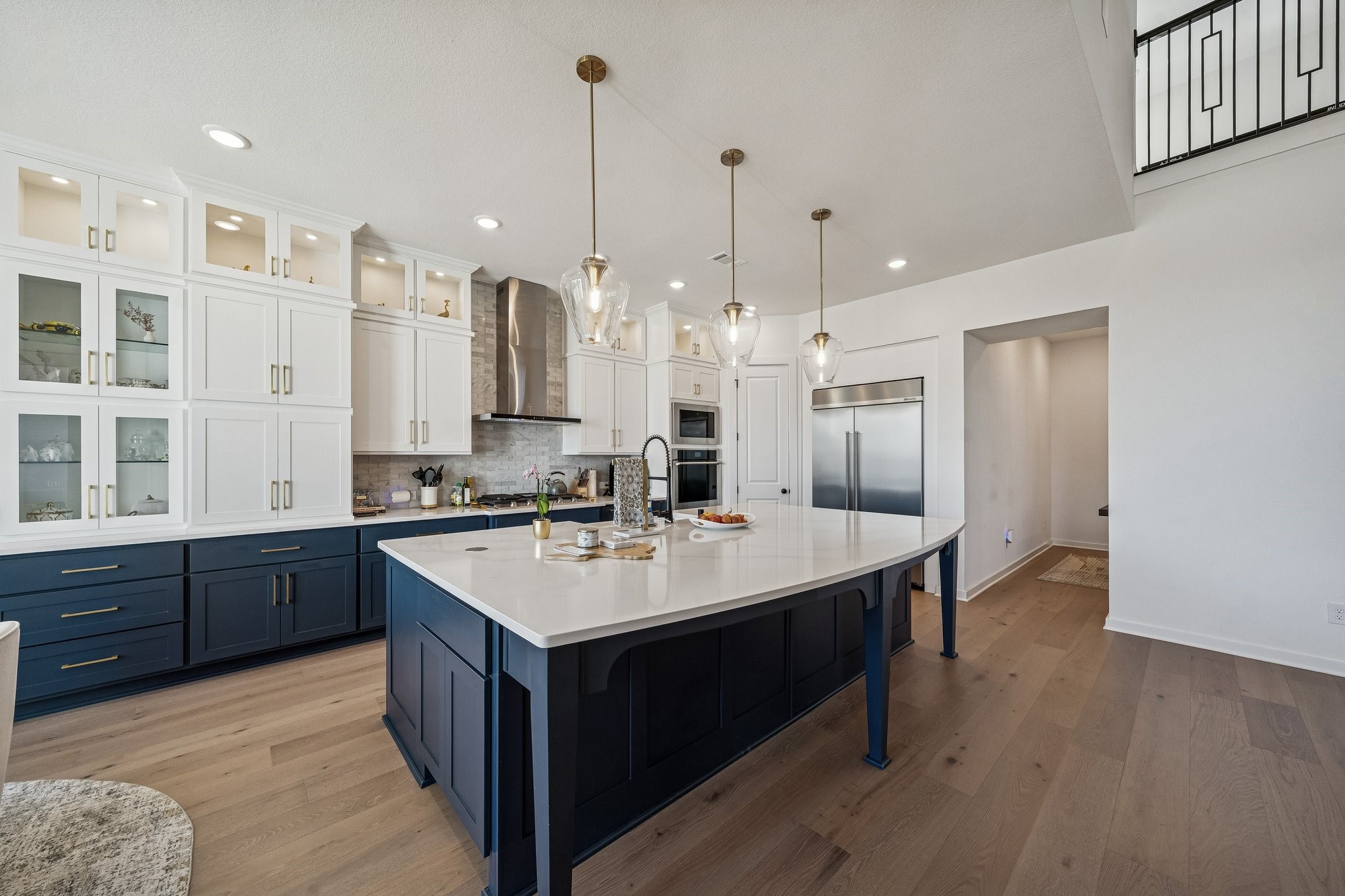 8703 Blue Grotto Lane Manvel, TX 77578 - Photo 9 of 43 The kitchen is a chef's dream complete with built-in, high-end refrigerator, two-tones cabinets and quartz counters.