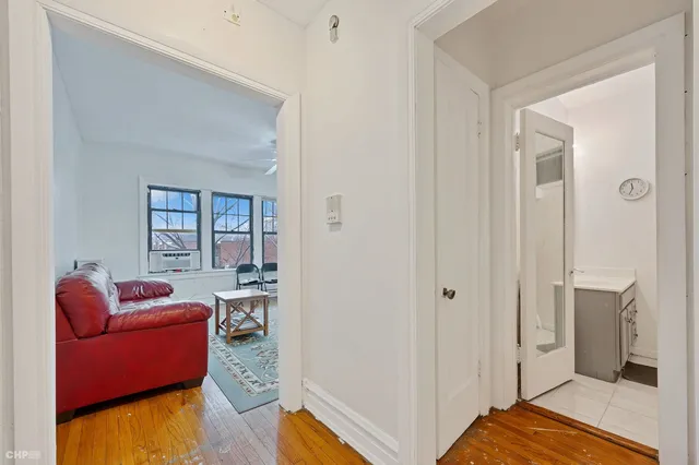 a bedroom with furniture and a wooden floor