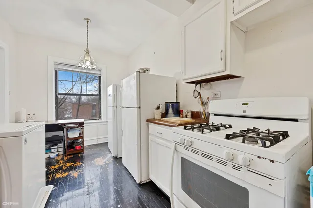 a kitchen with stove and white cabinets