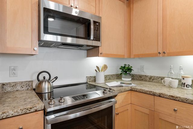a kitchen with a sink stove and microwave