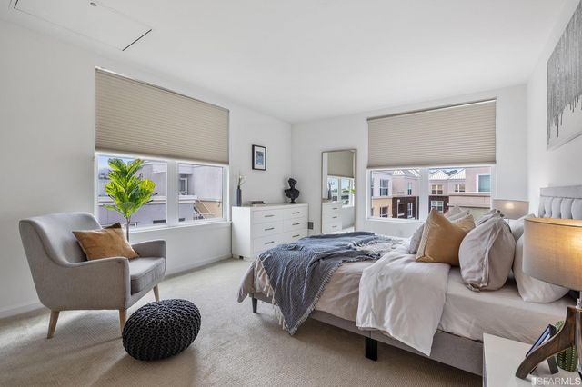 a bedroom with a bed and a couch