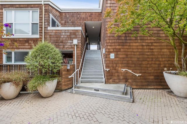 a view of a door of the house with outdoor seating