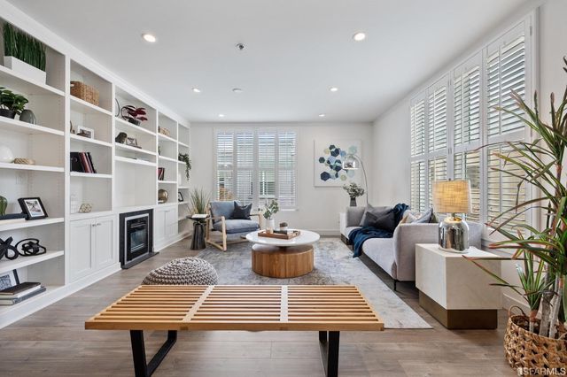 a living room with furniture a fireplace and a table