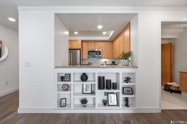 a kitchen with stainless steel appliances granite countertop a sink and a refrigerator