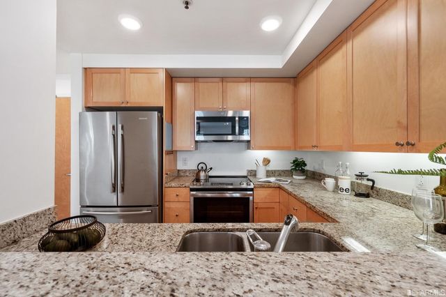 a kitchen with a sink stove and refrigerator