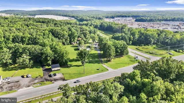 an aerial view of a residential houses with a yard and lake view