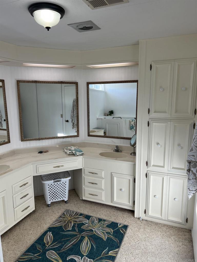 18218 Paradise Mountain Road, Unit SPACE 83 Valley Center, CA 92082 - Photo 15 of 50 a spacious bathroom with a granite countertop sink and a mirror