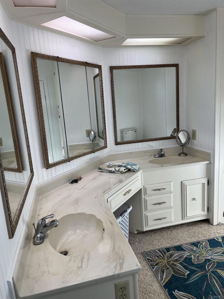 18218 Paradise Mountain Road, Unit SPACE 83 Valley Center, CA 92082 - Photo 17 of 50 a bathroom with a sink and a mirror
