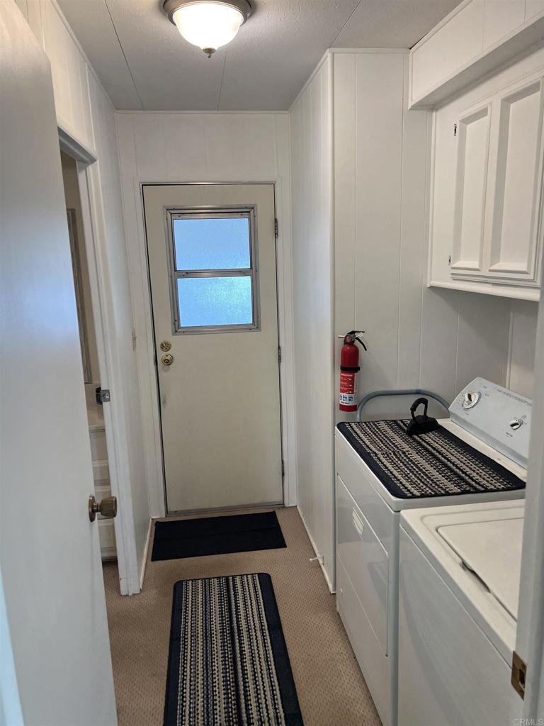 18218 Paradise Mountain Road, Unit SPACE 83 Valley Center, CA 92082 - Photo 19 of 50 a room with washing machine and cabinets