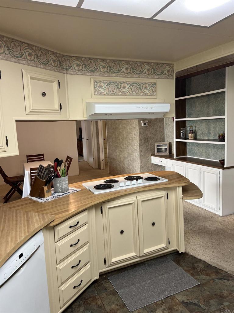 18218 Paradise Mountain Road, Unit SPACE 83 Valley Center, CA 92082 - Photo 22 of 50 a kitchen with granite countertop a sink and cabinets