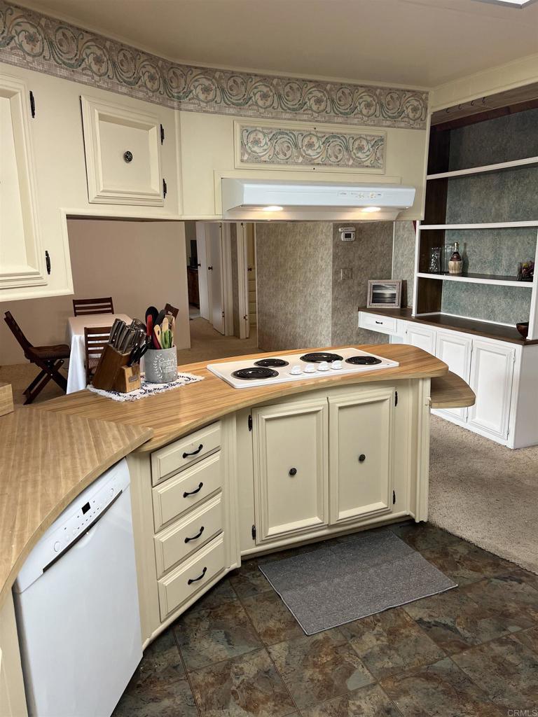 18218 Paradise Mountain Road, Unit SPACE 83 Valley Center, CA 92082 - Photo 23 of 50 a kitchen with cabinets and window