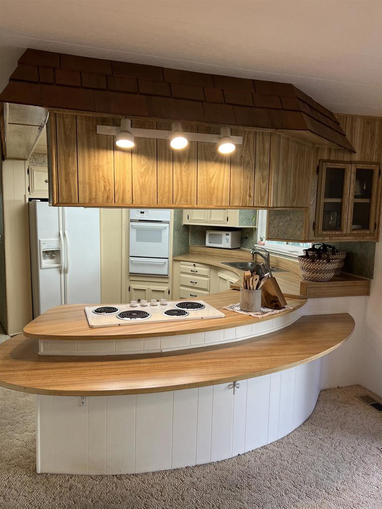 18218 Paradise Mountain Road, Unit SPACE 83 Valley Center, CA 92082 - Photo 24 of 50 a kitchen with stainless steel appliances granite countertop a sink a stove and a cabinets