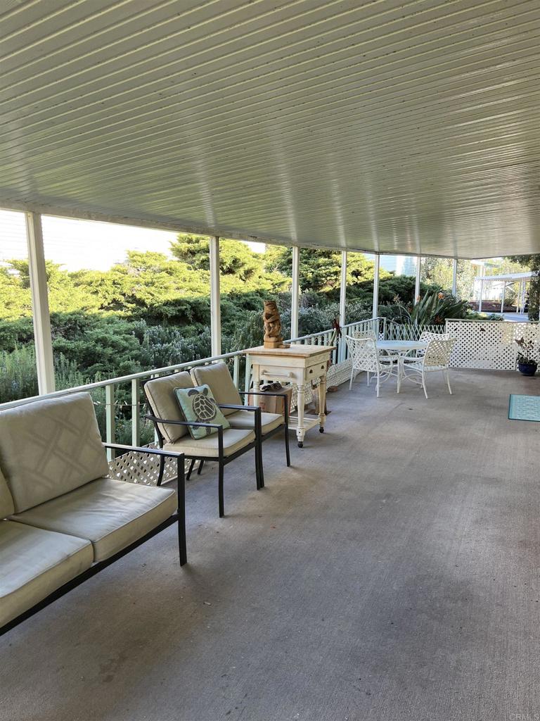 18218 Paradise Mountain Road, Unit SPACE 83 Valley Center, CA 92082 - Photo 31 of 50 a view of a patio with couches and table and chairs under an umbrella