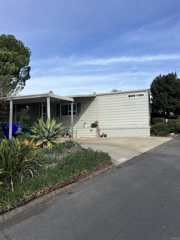 18218 Paradise Mountain Road, Unit SPACE 83 Valley Center, CA 92082 - Photo 37 of 50 a front view of house with yard and green space