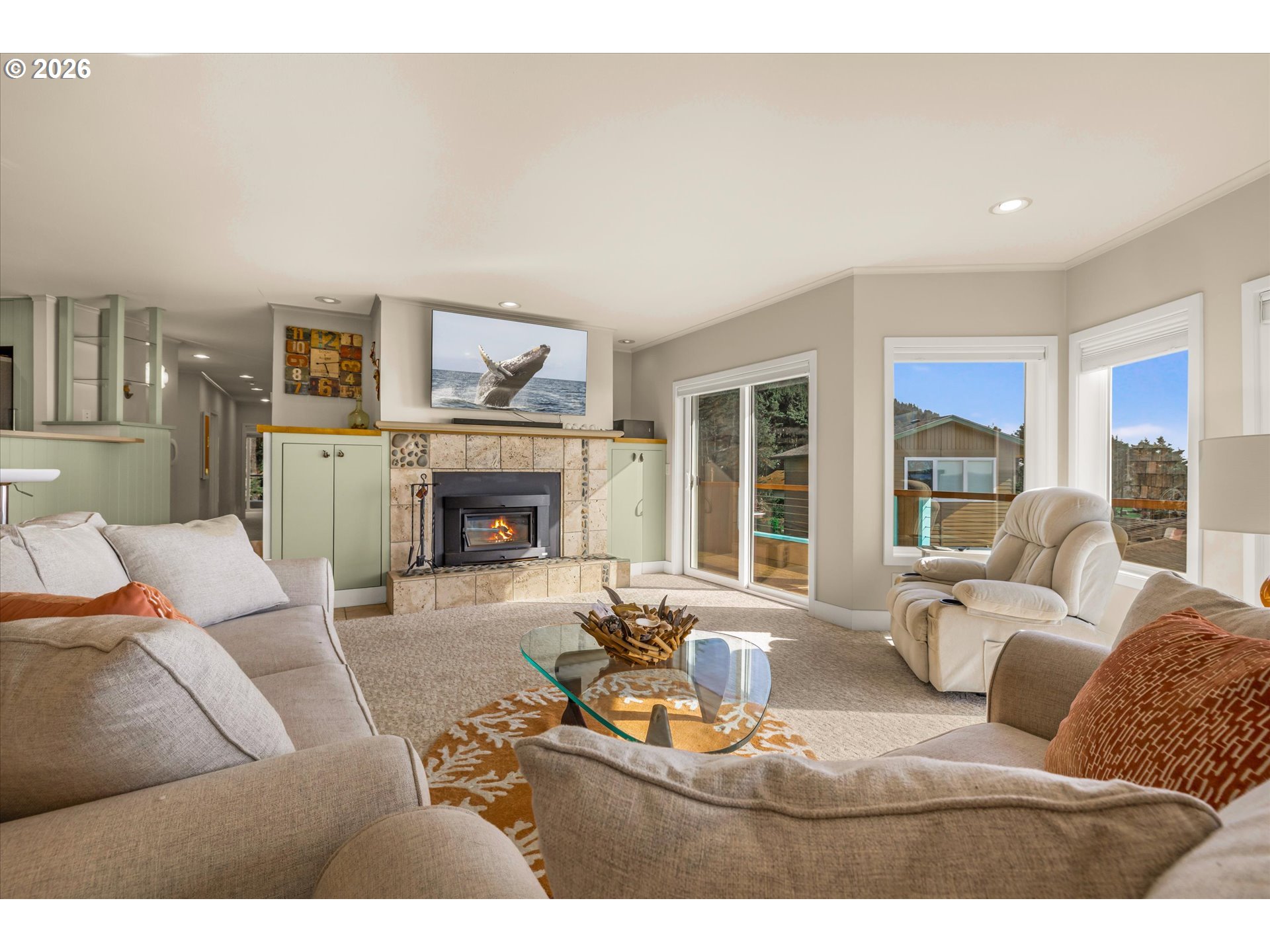 438 Shellmidden Way Yachats, OR 97498 - Photo 12 of 40 a living room with furniture a large window and a fireplace