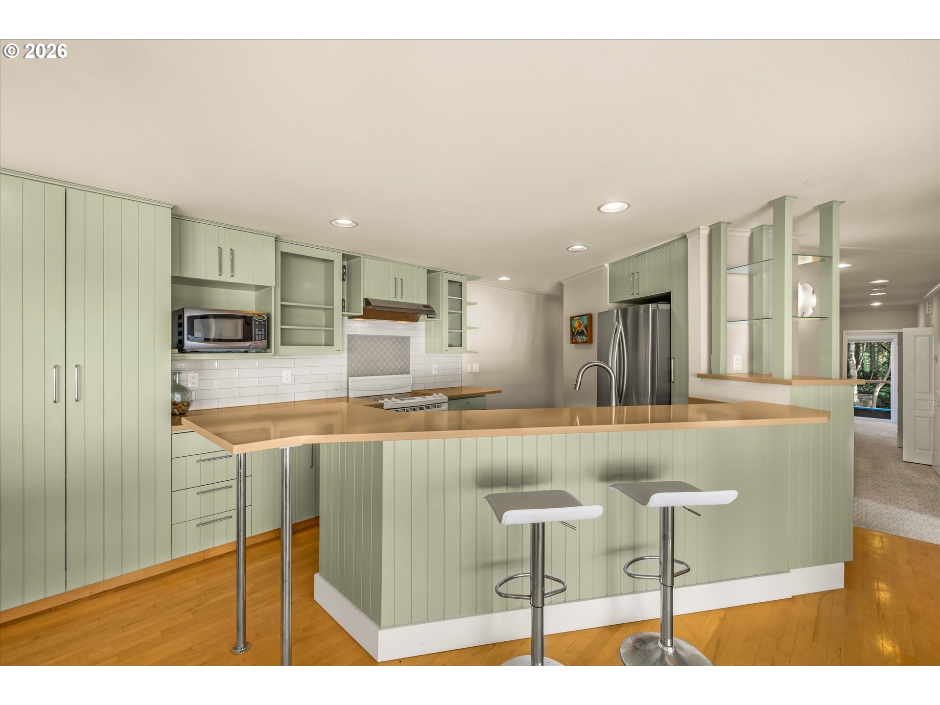 438 Shellmidden Way Yachats, OR 97498 - Photo 15 of 40 a kitchen with stainless steel appliances granite countertop a sink and a refrigerator