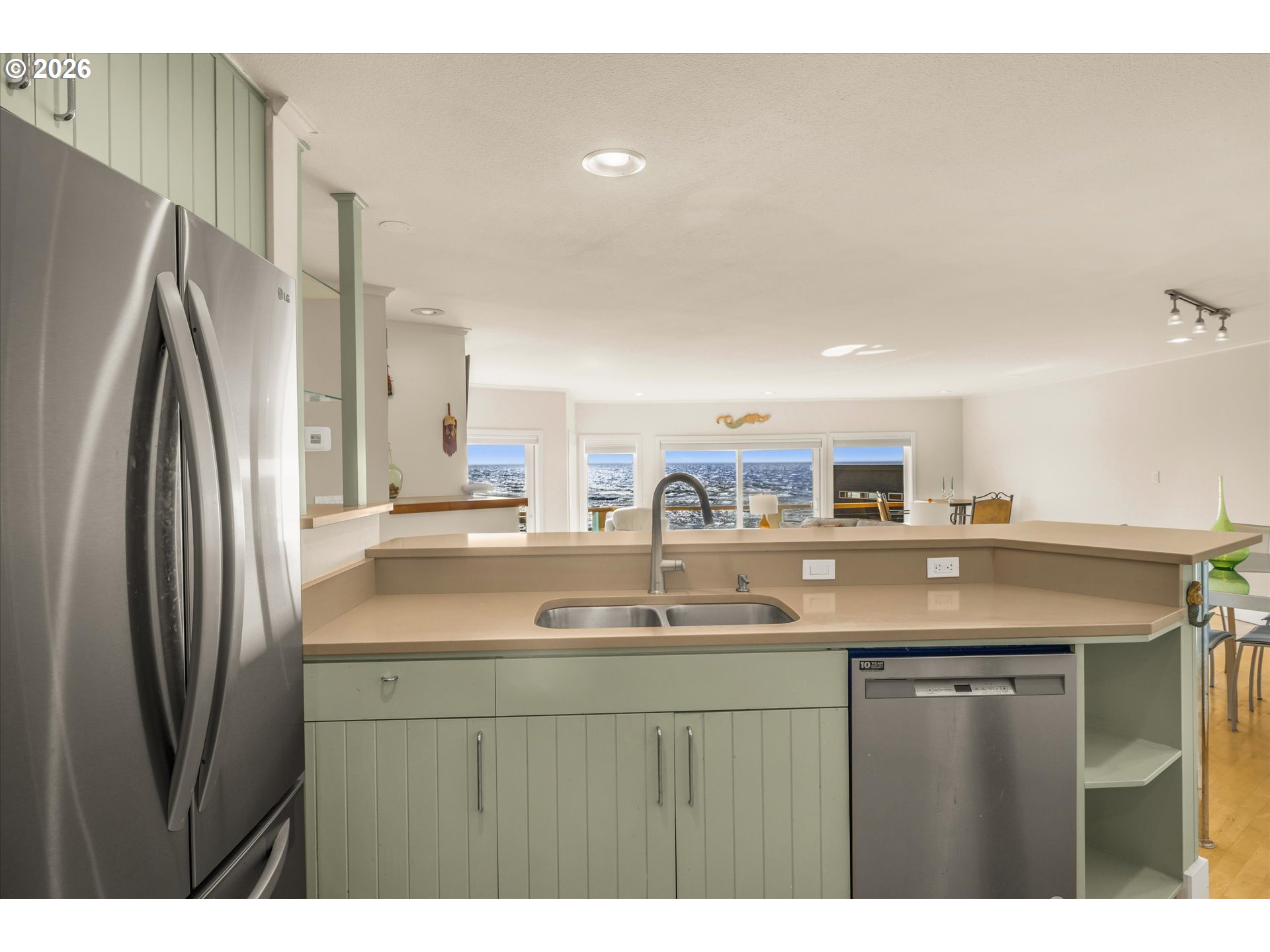 438 Shellmidden Way Yachats, OR 97498 - Photo 17 of 40 a kitchen with a sink and a refrigerator