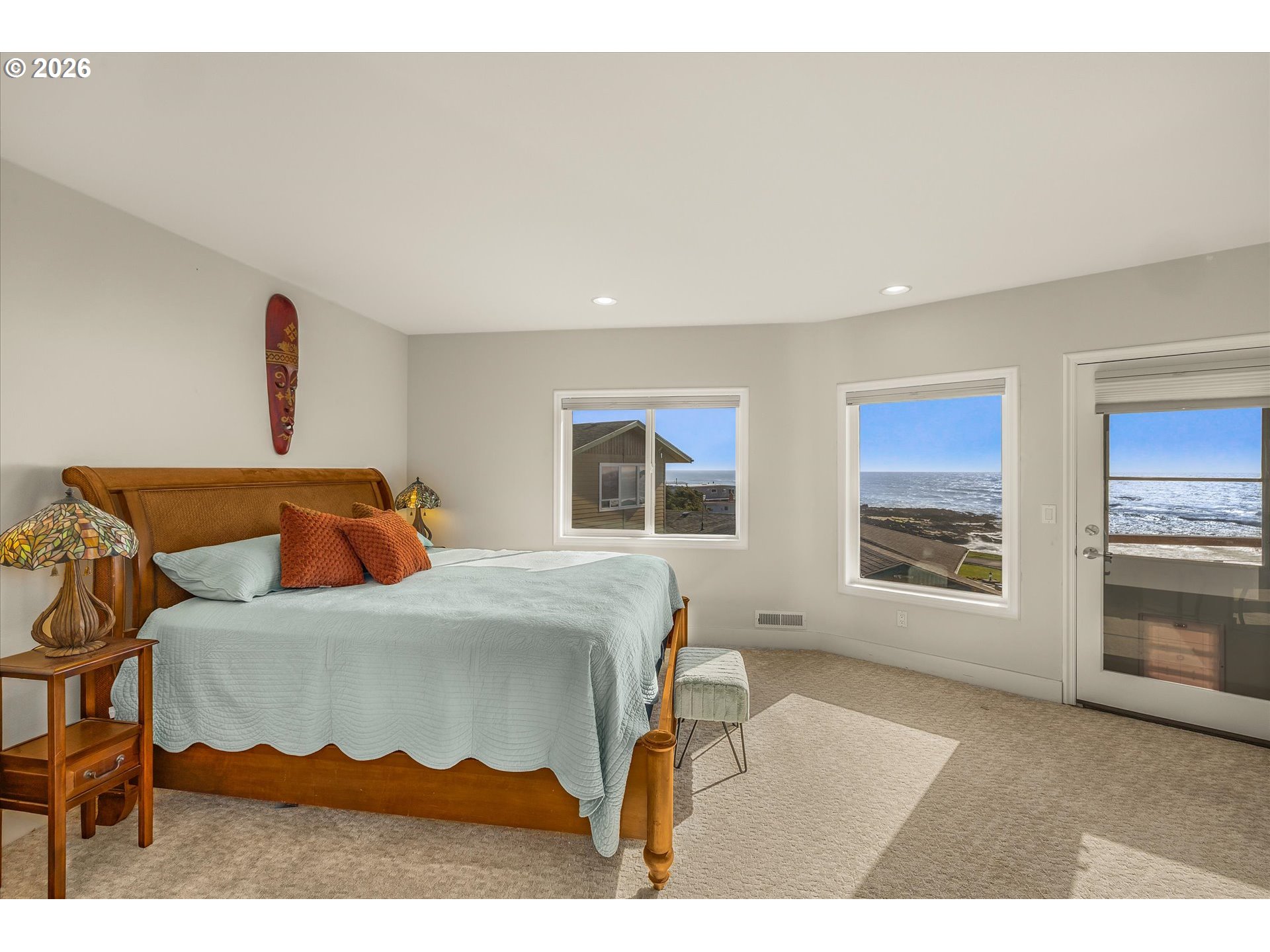 438 Shellmidden Way Yachats, OR 97498 - Photo 21 of 40 a bedroom with a bed and a large window