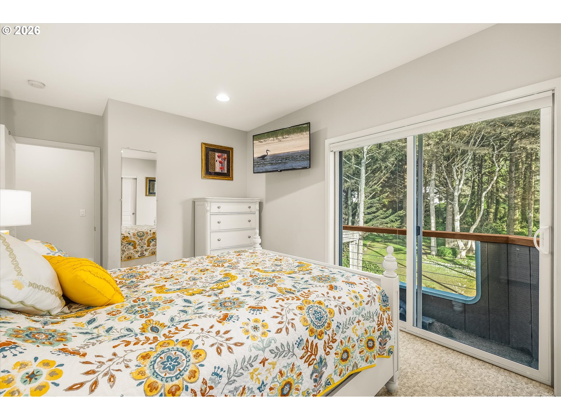 438 Shellmidden Way Yachats, OR 97498 - Photo 26 of 40 a bedroom with a large bed and a window