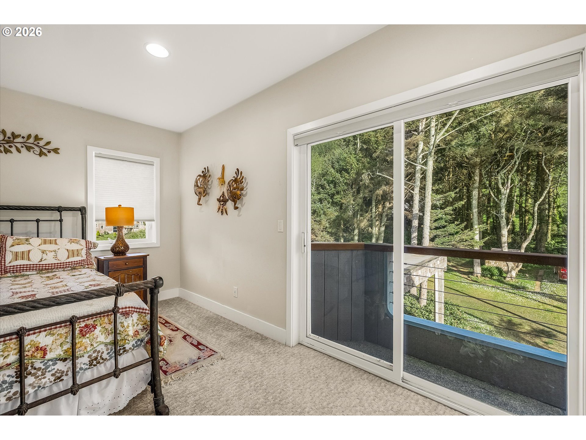 438 Shellmidden Way Yachats, OR 97498 - Photo 29 of 40 a bedroom with furniture and a window