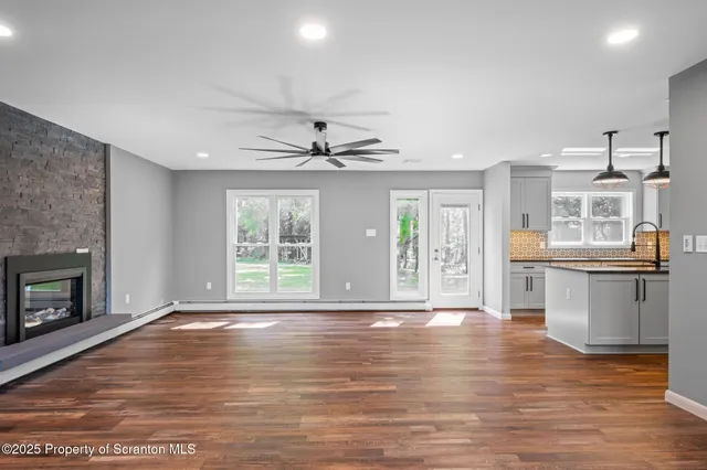 a kitchen with granite countertop a refrigerator a oven and a sink