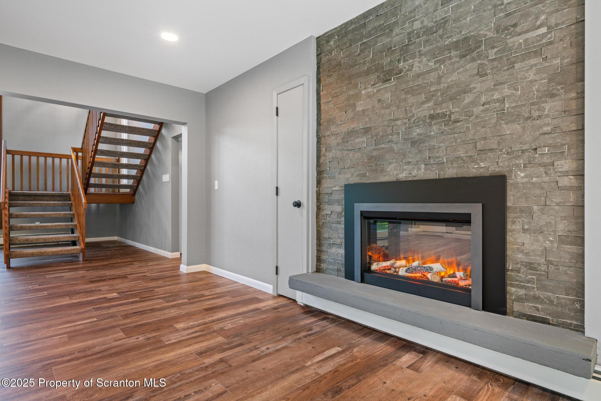 2001 Cleveland Avenue Scranton, PA 18505 - Photo 12 of 87 a view of an empty room with wooden floor fire place and a fireplace